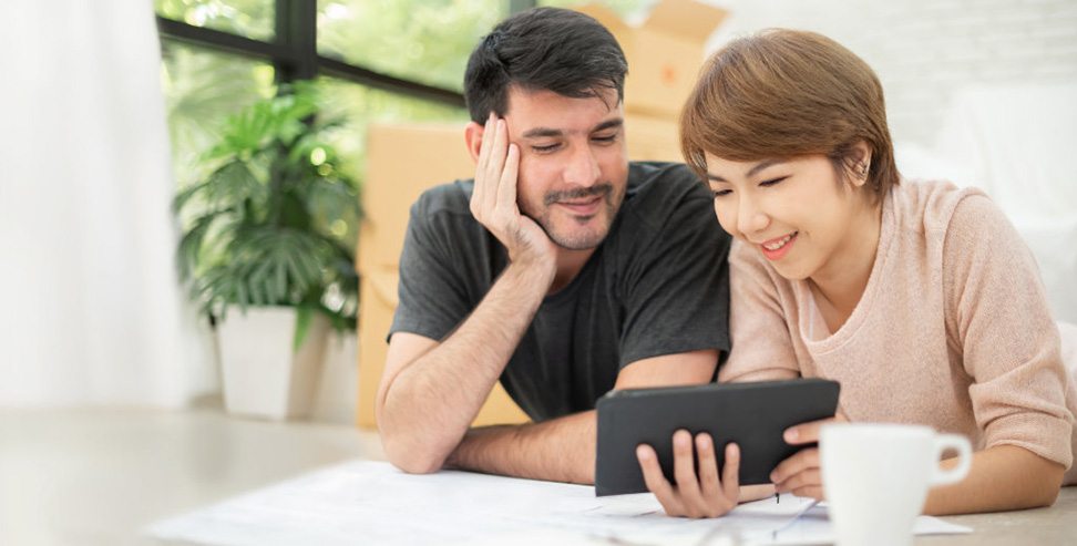 Couple looking at a tablet.