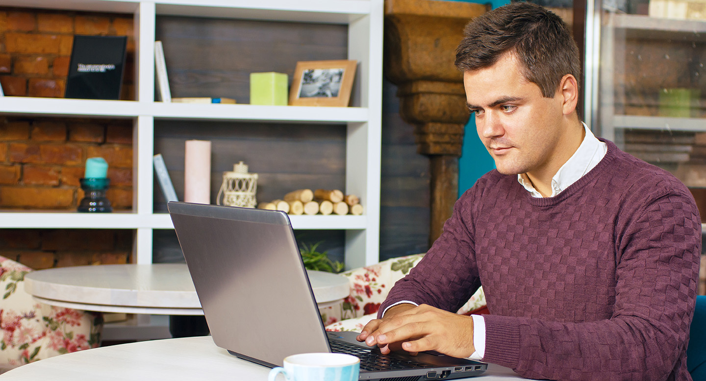 Man using a laptop to order a divore certificate from VitalChek.