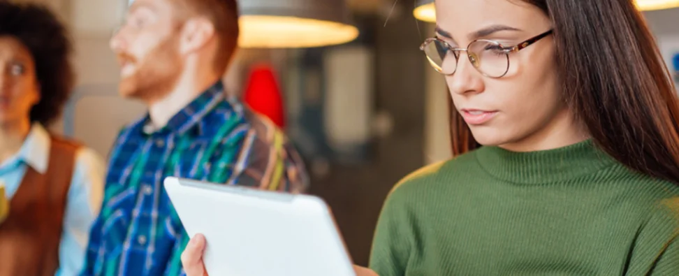 Woman reading about why VitalChek is the best choice for ordering vital records.